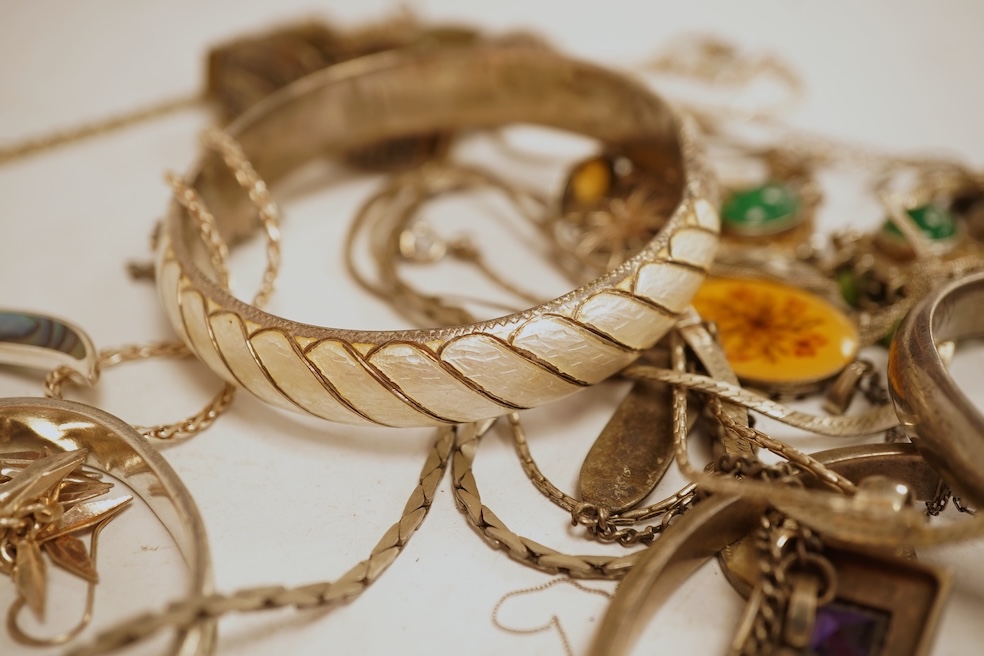 A small group of silver and white metal jewellery including Siamese enamelled bangle, silver chain, drop earrings, Persian coin brooch, etc.